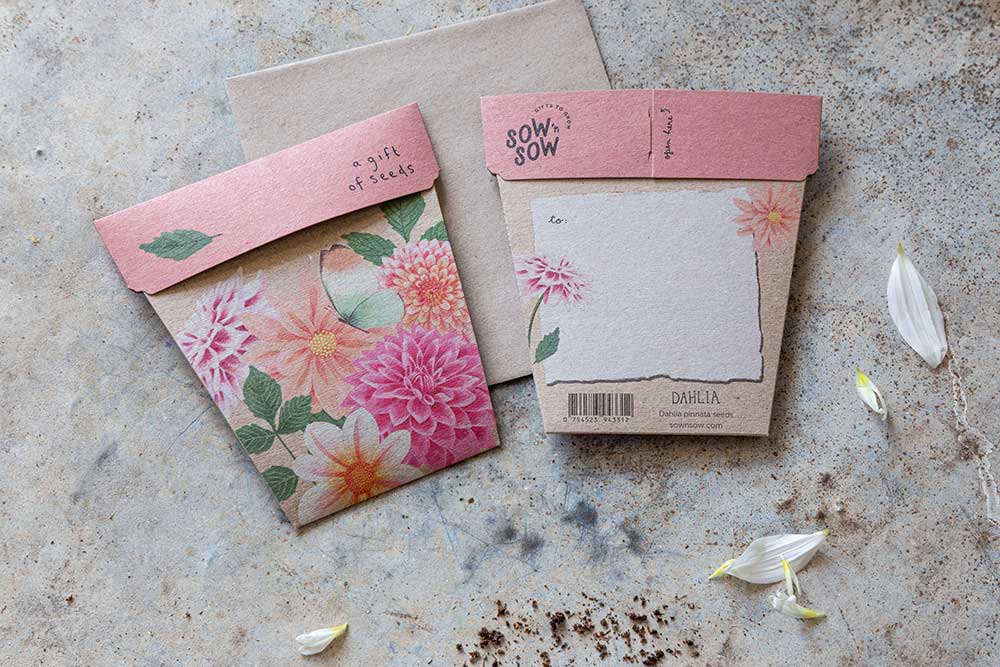 Floral stationery set with envelopes and a notepad on a textured surface.