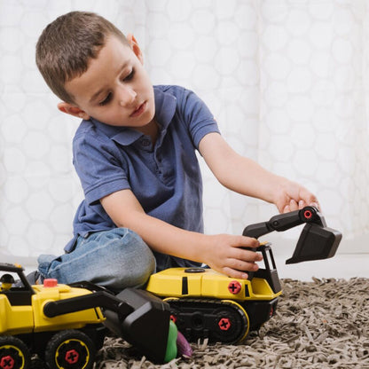 Child playing with a toy excavator on a carpeted floor.