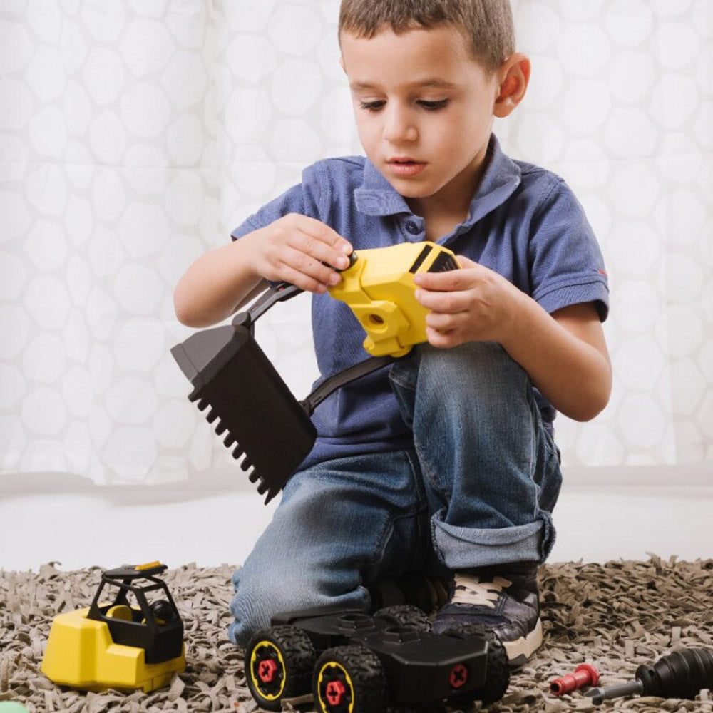 Child playing with toy tools on a carpeted floor
