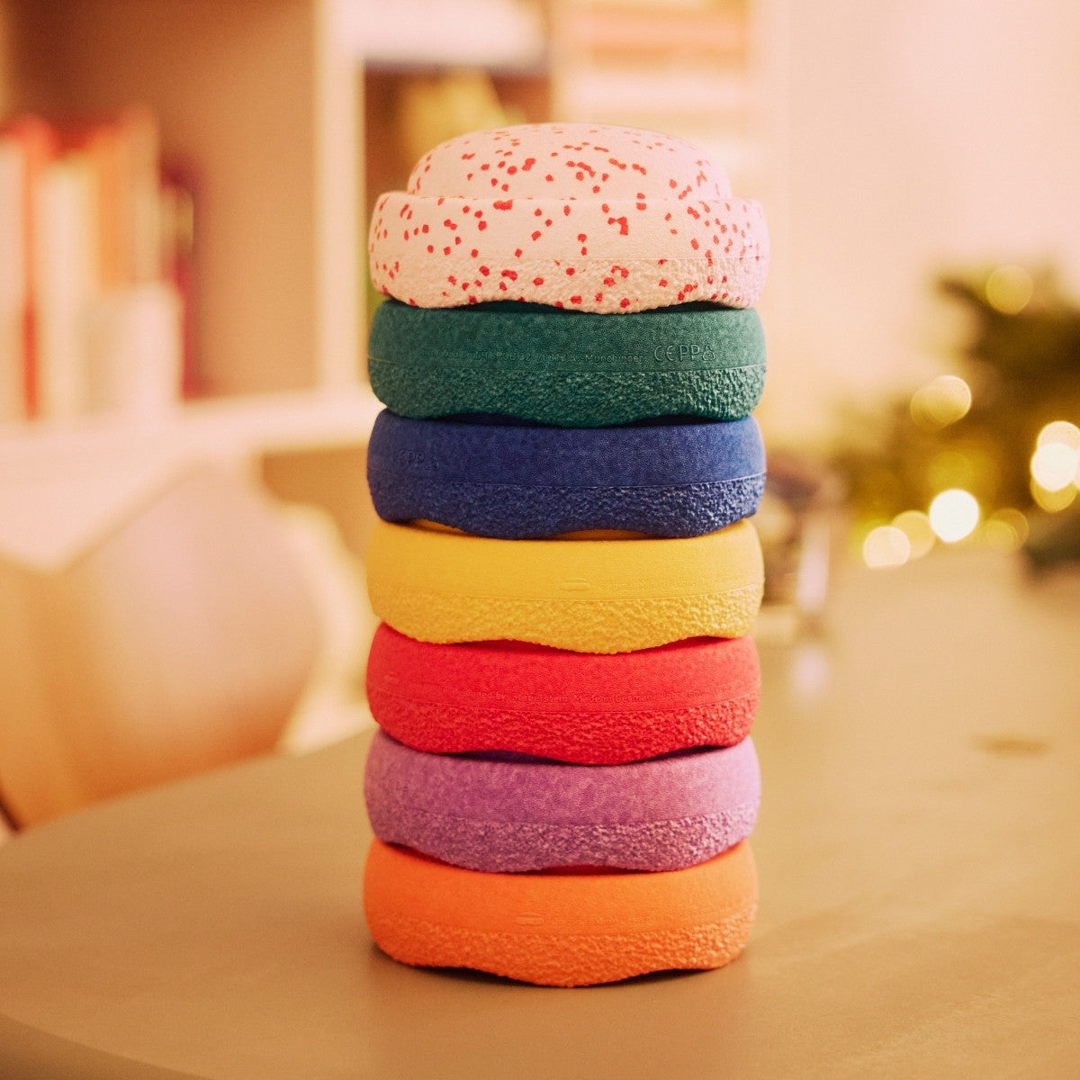 Stack of colorful Stapelstein stepping stones on a blurred indoor background
