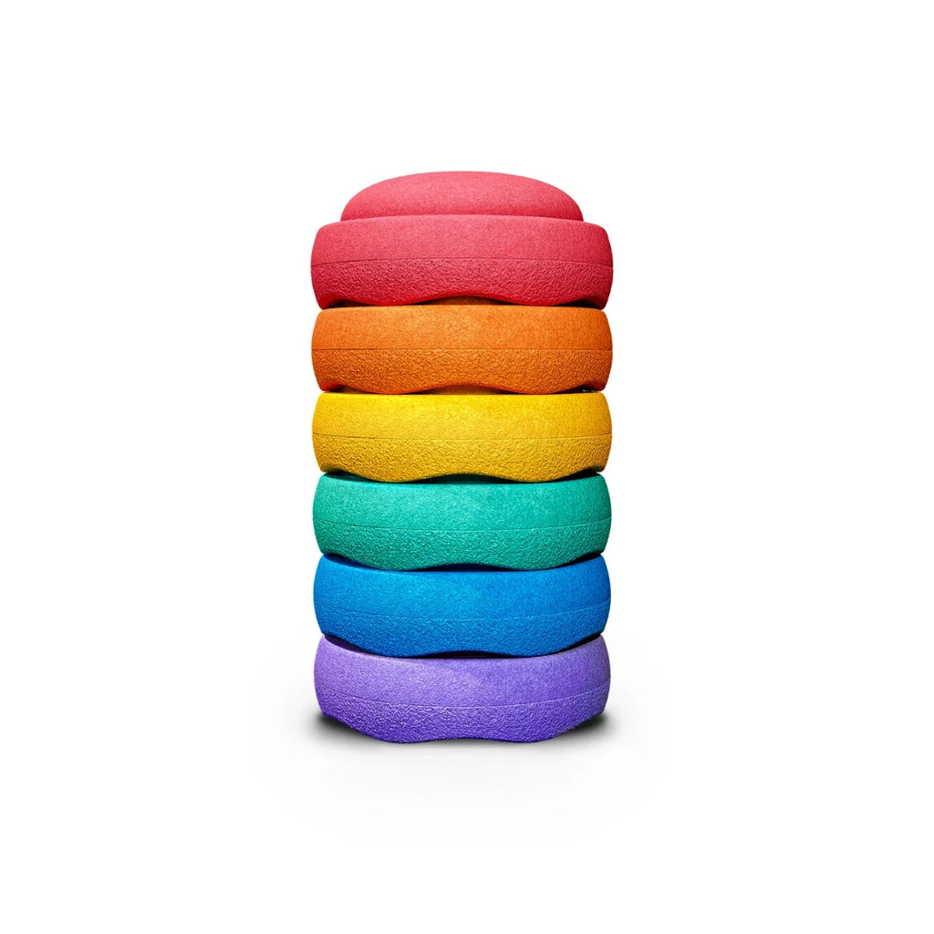 Stack of colorful stepping stones on a white background