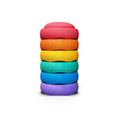 Stack of colorful stepping stones on a white background