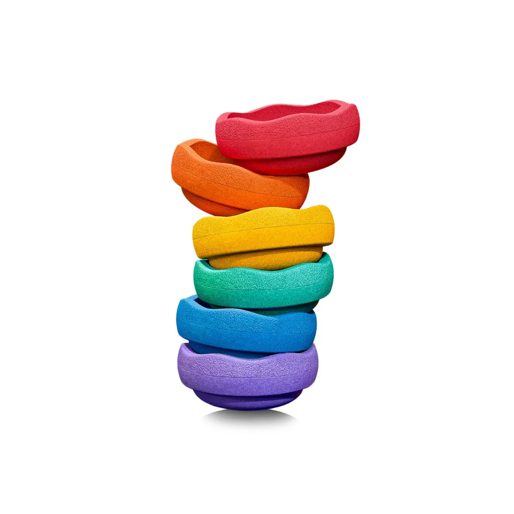 A stack of six textured, wavy stepping stones in a rainbow color sequence (red, orange, yellow, green, blue, purple) on a solid white background.