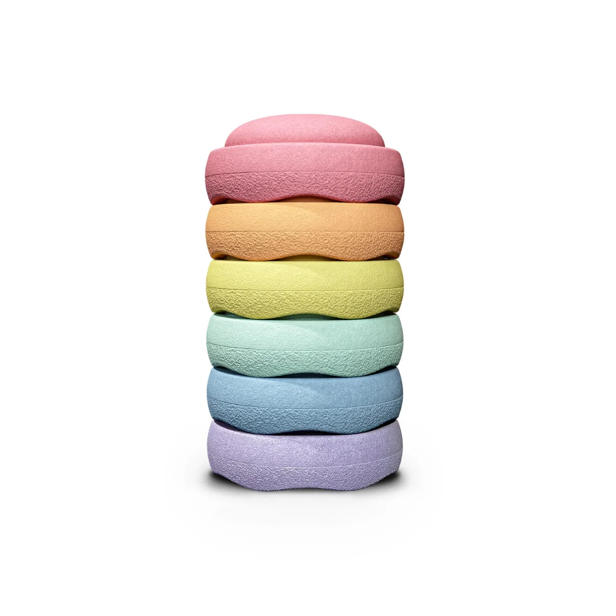 A stack of six textured, donut-shaped bath or body soaps in pastel rainbow colors, including pink, orange, yellow, mint green, light blue, and lavender, set against a solid white background.