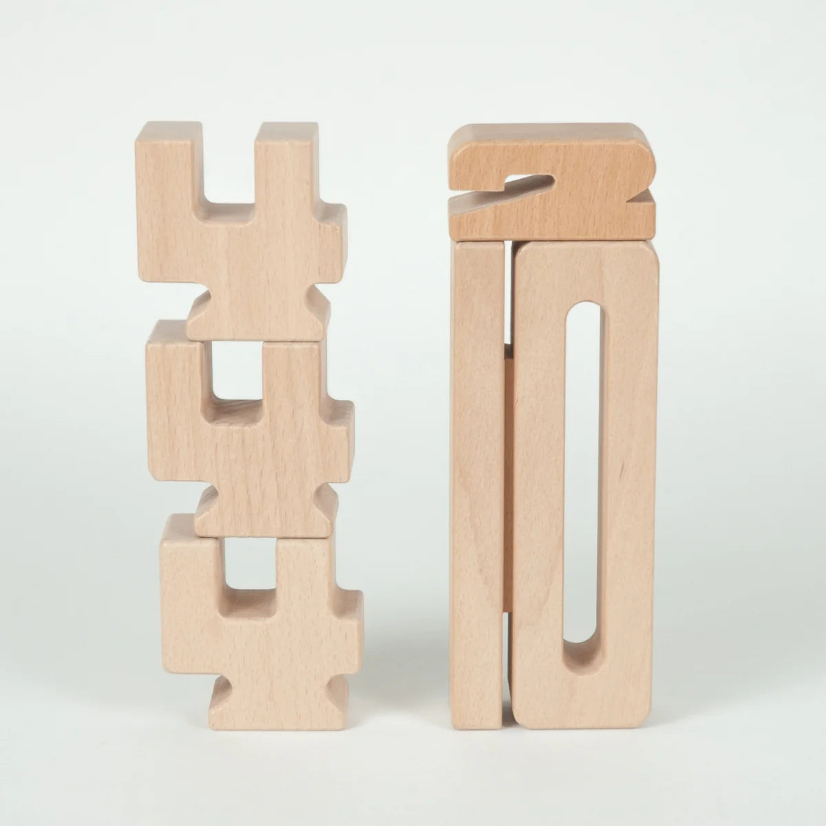 Two wooden geometric sculptures on a white background using SumBlox