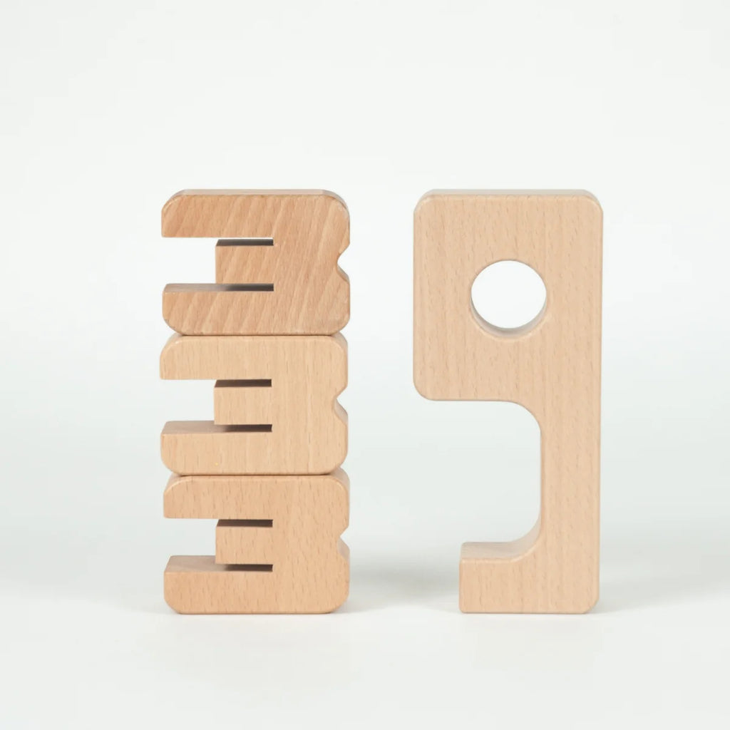Two wooden blocks with geometric shapes on a white background