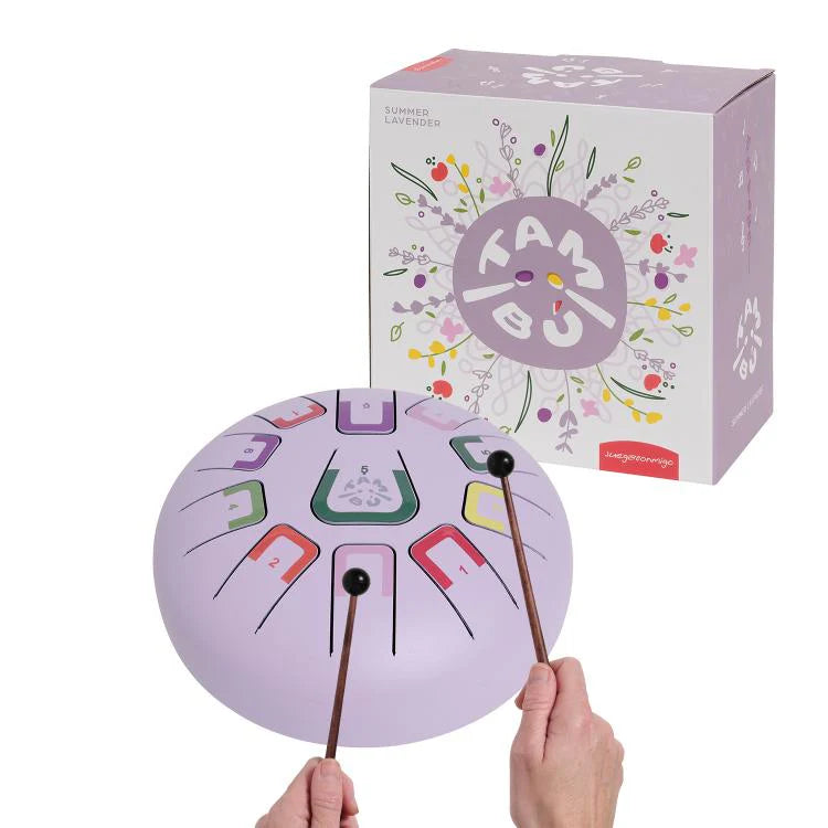Purple hand drum with colorful letters and two sticks, next to its packaging box on a white background.