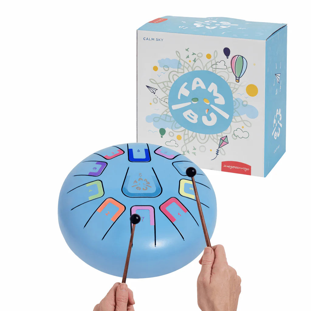 Blue metal tongue drum with drumsticks and its packaging on a white background