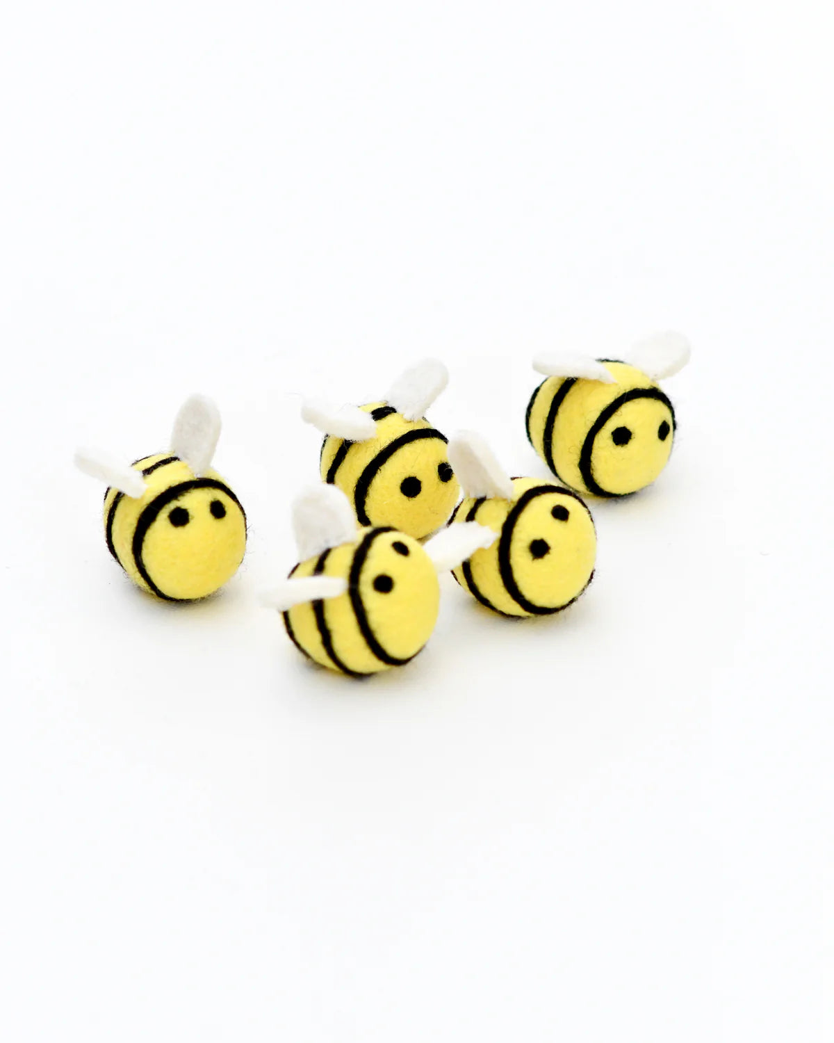 Five small bee-shaped toys on a white background