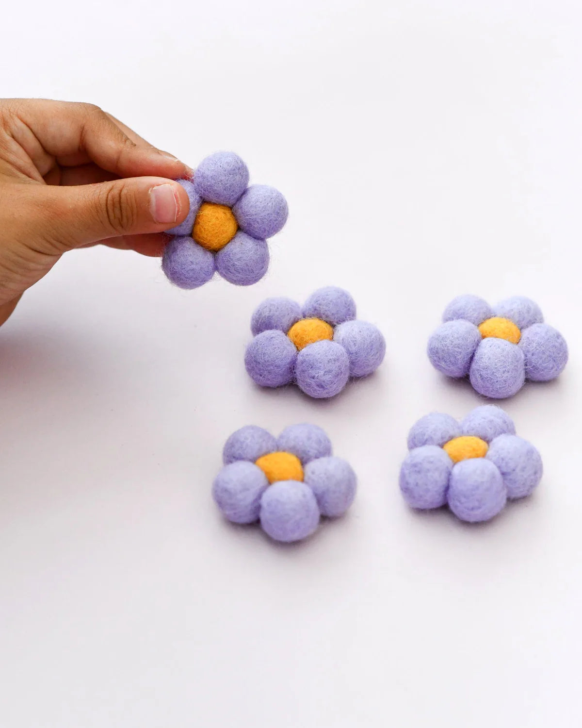 Handmade lavender flowers with yellow centers on a white background