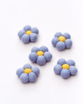 Set of five blue flower-shaped objects with yellow centers on a white background