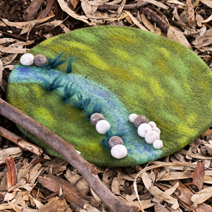 Decorative stone with felted elements on a natural background