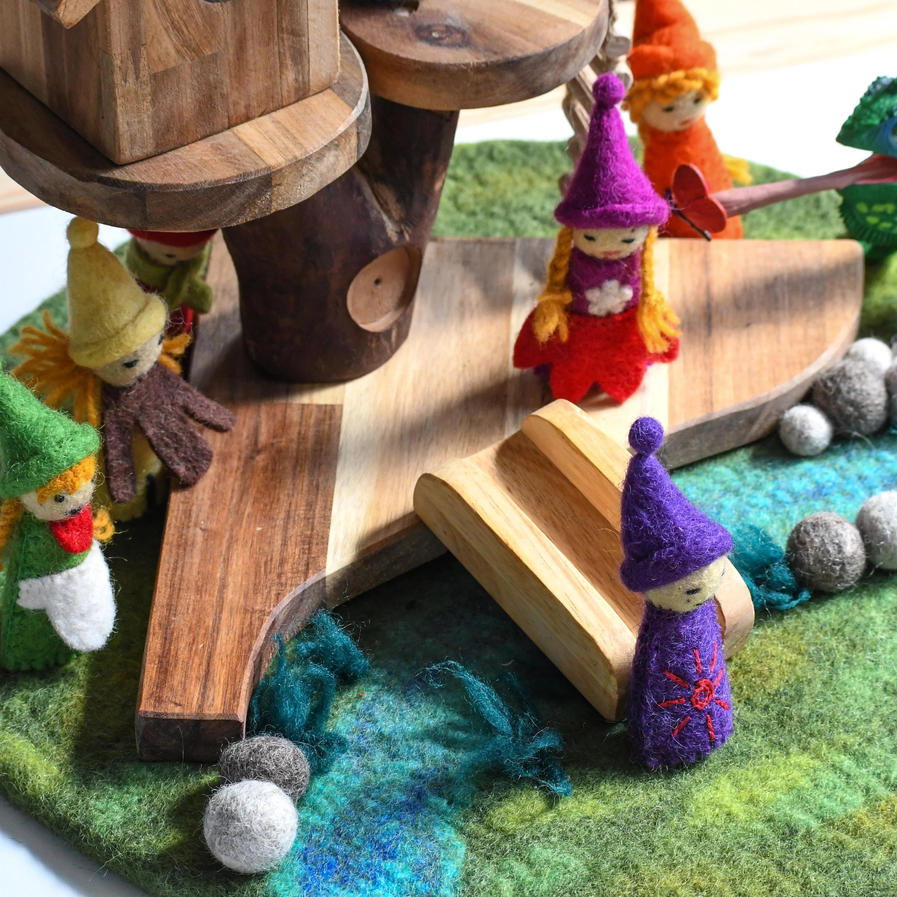 Wooden toy with small figurines on a colorful base