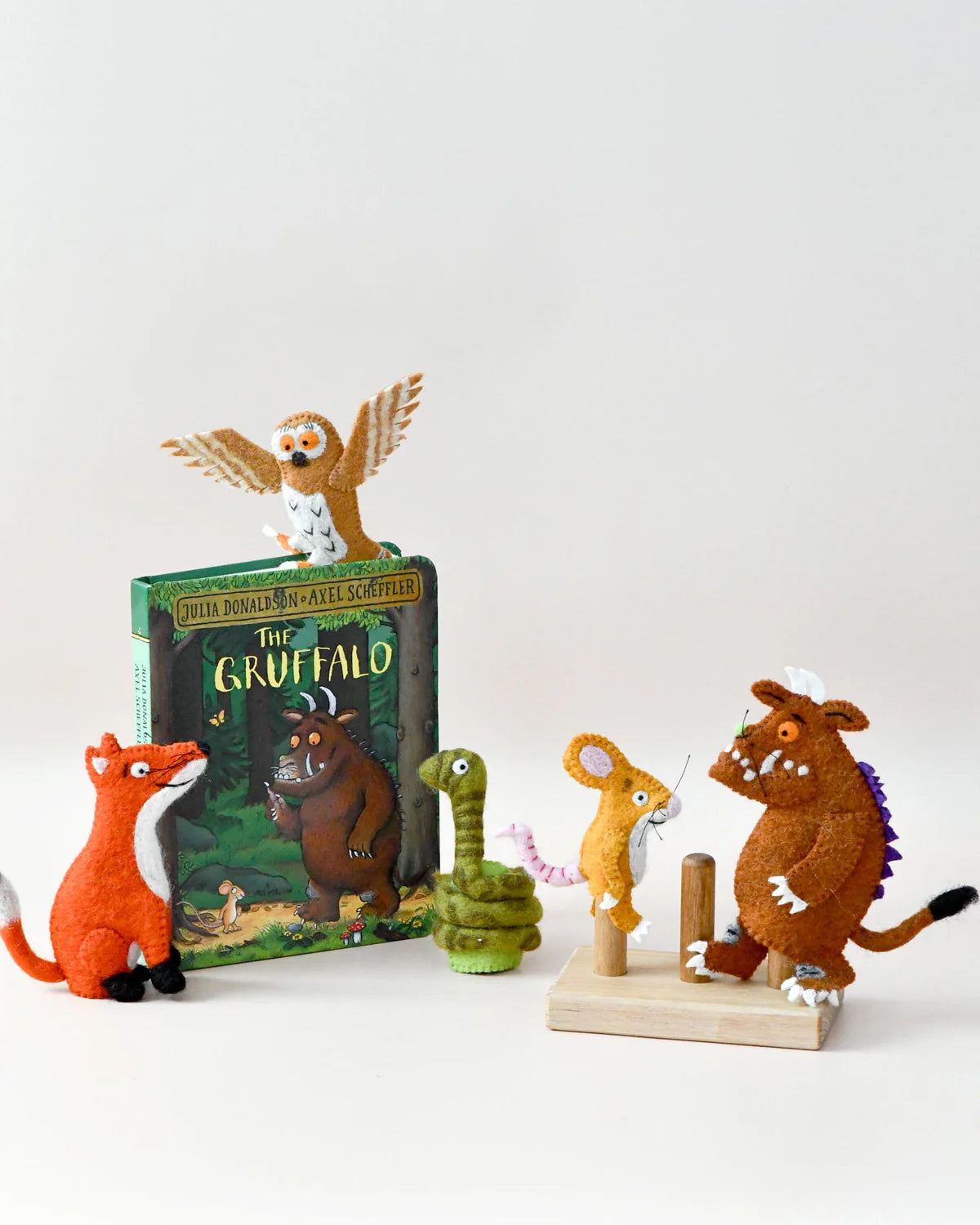 Toy figurines of characters from 'The Gruffalo' book on a white background
