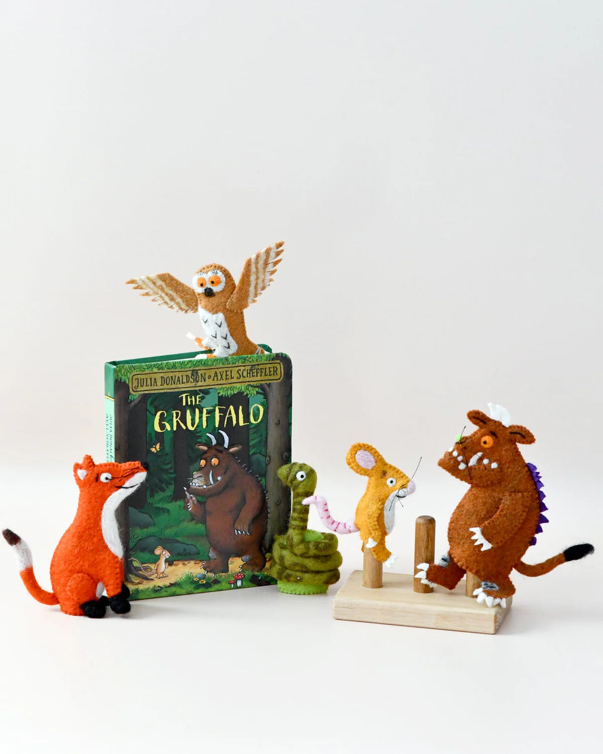 Toy figurines of animals from 'The Gruffalo' book on a white background