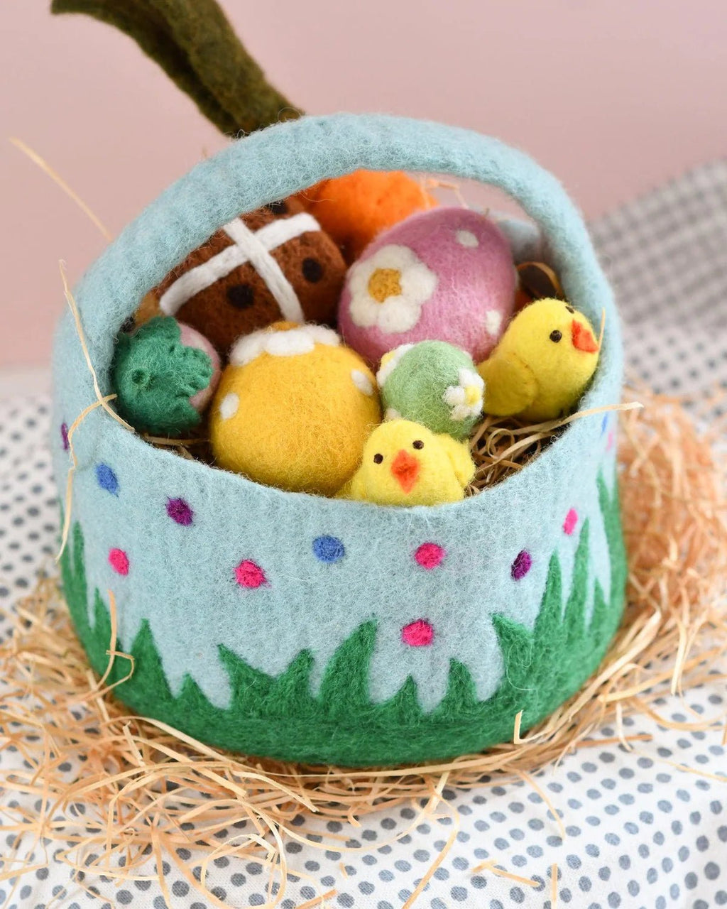 Felt Easter basket with colorful eggs and chicks on a textured surface