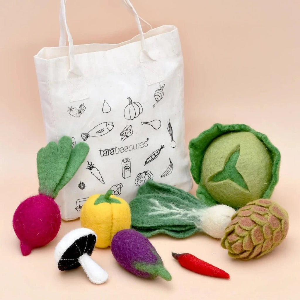 Tote bag with vegetable illustrations and felt vegetable toys on a beige background