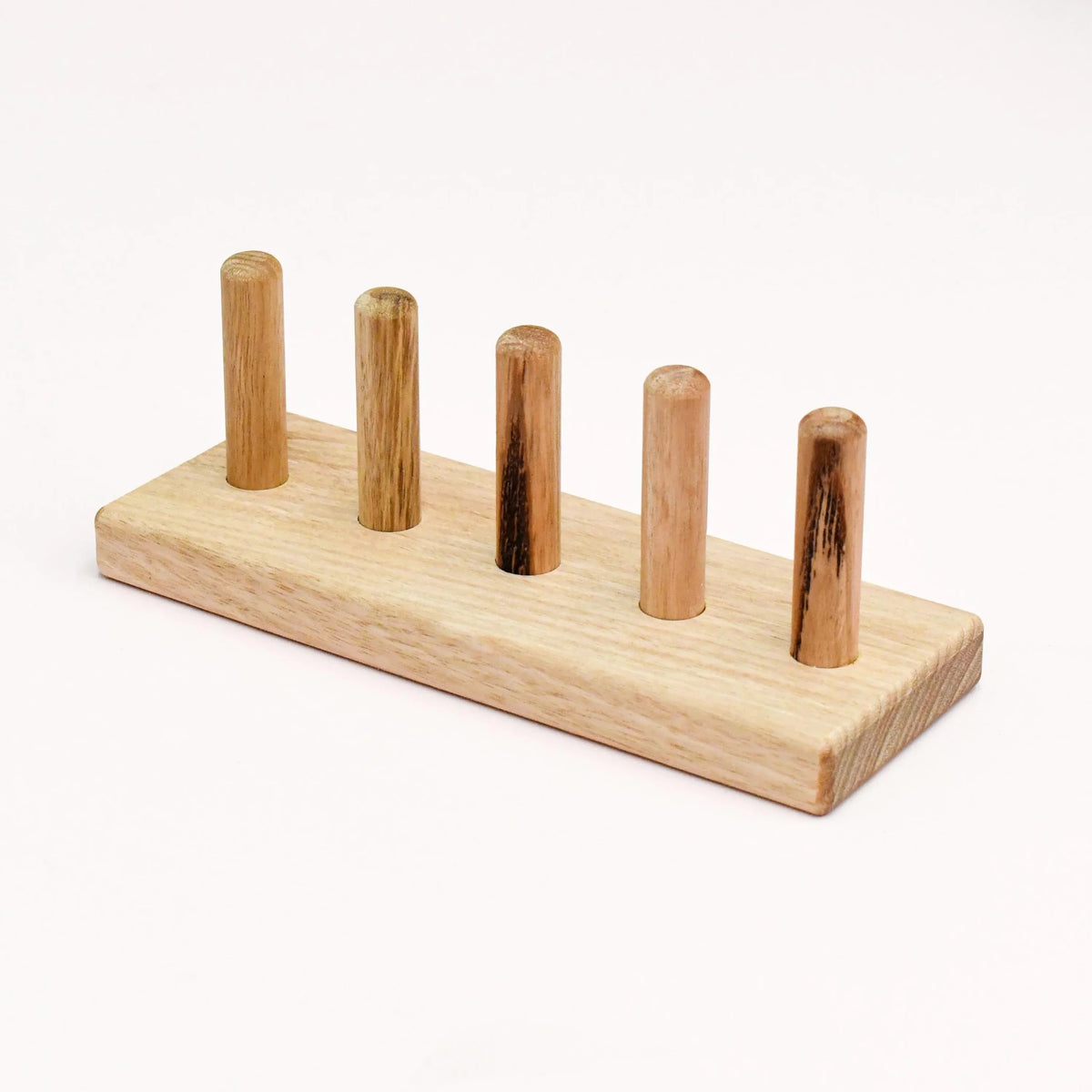 Wooden stand with five vertical wooden rods on a white background
