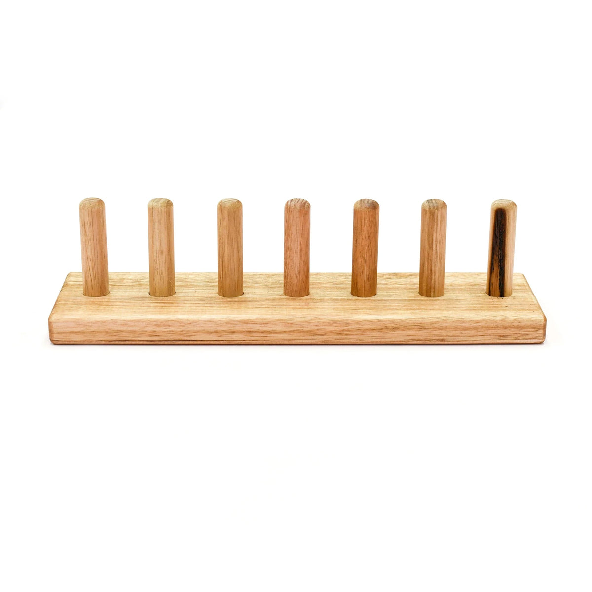 A natural wood menorah with seven upright pegs on a rectangular base, shown against a plain white background.