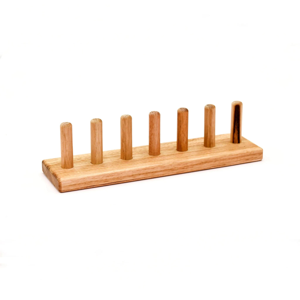 Wooden toothbrush holder with multiple slots on a white background