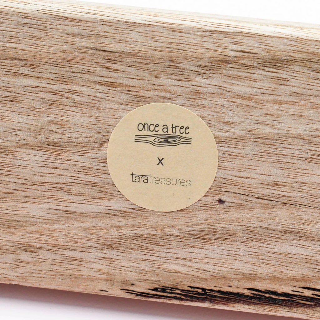 Wooden product with a 'once a tree' and 'taratreasures' label.
