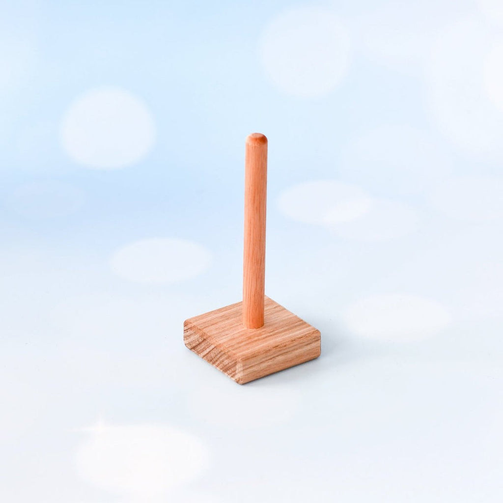 Wooden paper towel holder on a light blue background