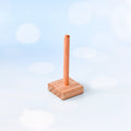 Wooden paper towel holder on a light blue background