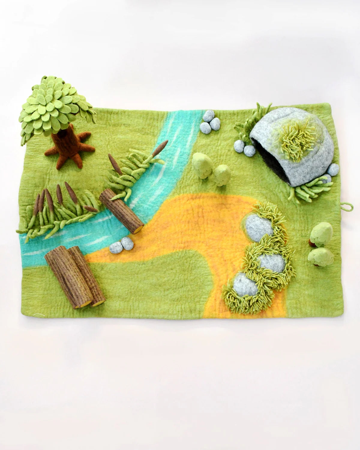 Felt craft of a nature scene with trees, rocks, and a stream on a white background