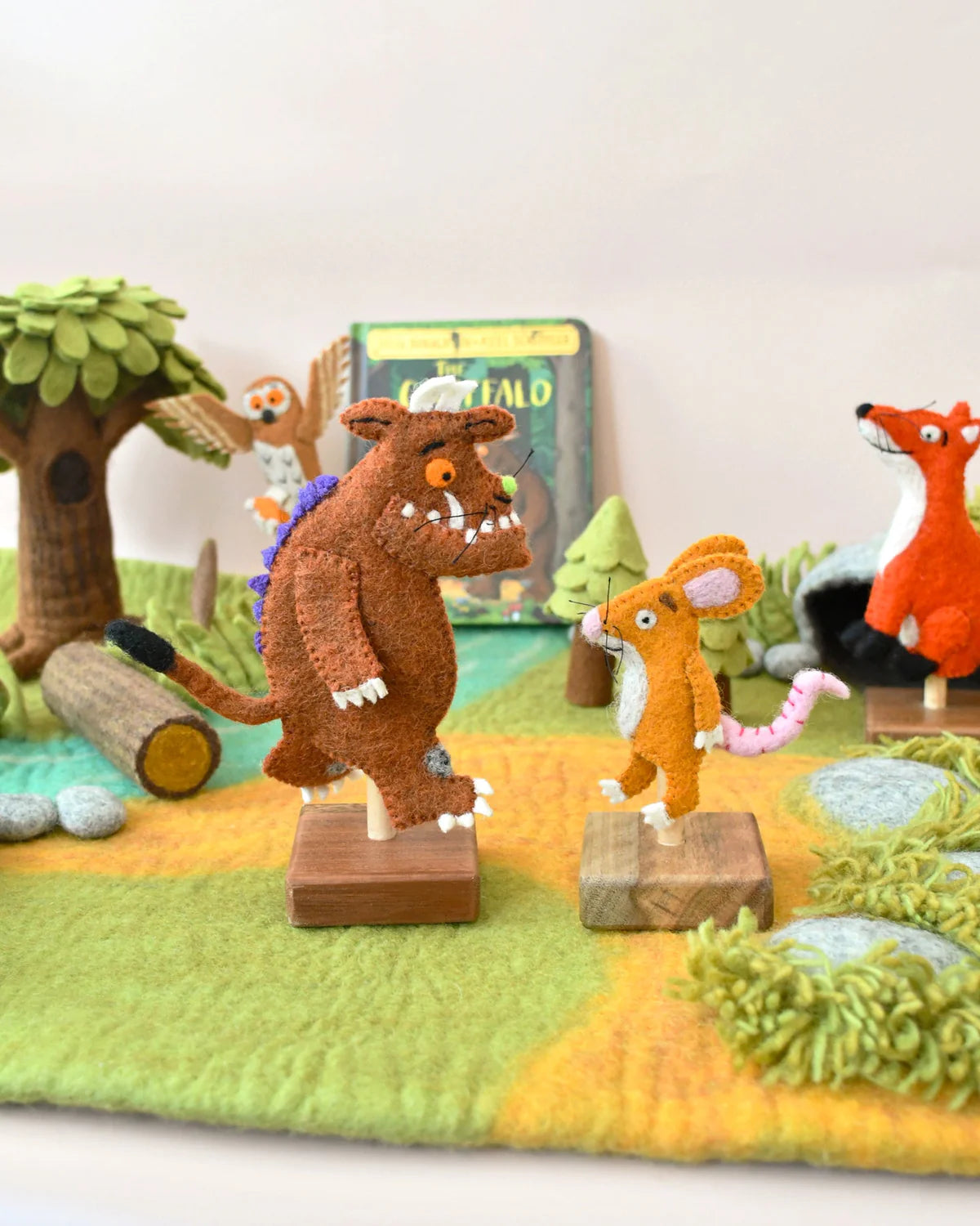 Toy figures of animals from a children's book on a staged background