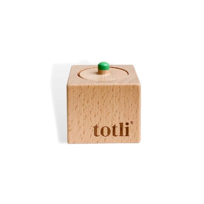 Wooden block with a green knob on top, branded 'totli', on a white background