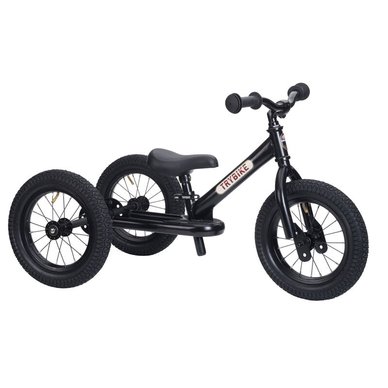 Black balance bike on a white background
