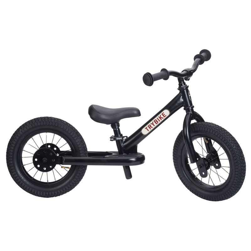 Black balance bike with 'TRYBIKE' branding on a white background