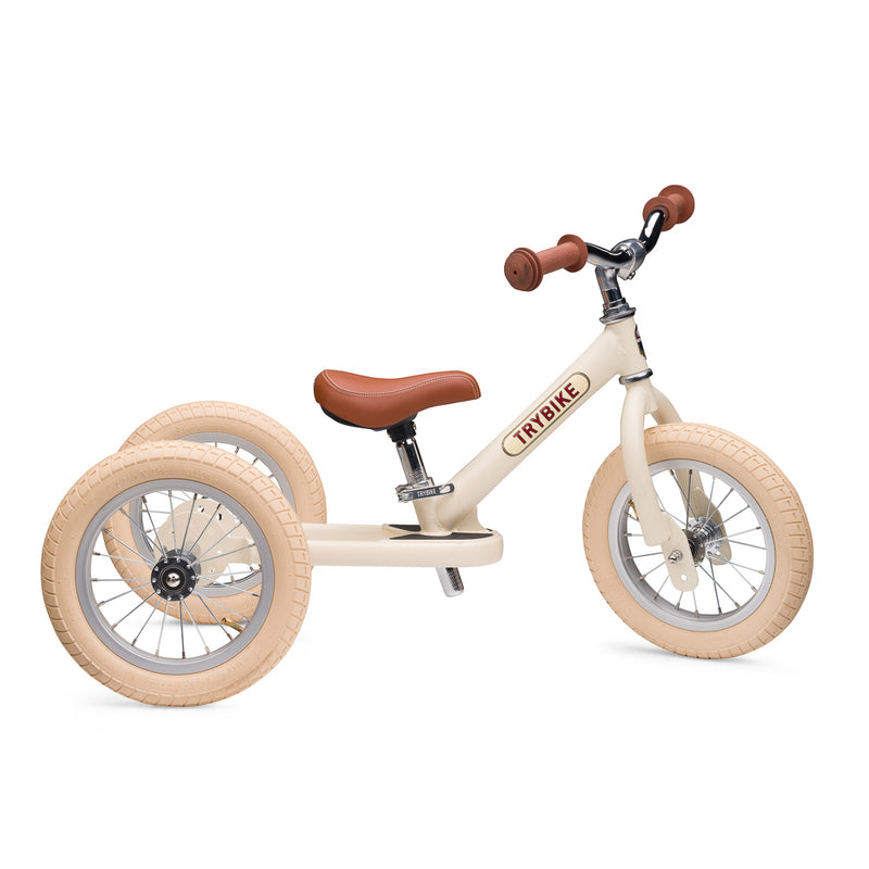 Children's balance bike with wooden finish on a white background