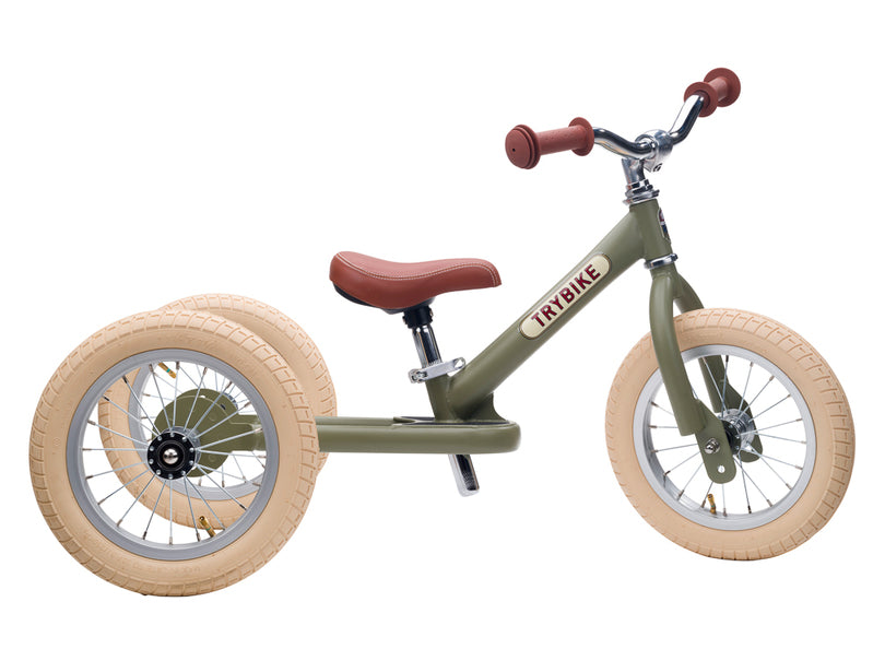 Children's balance bike with beige tires and brown handlebar grips on a white background