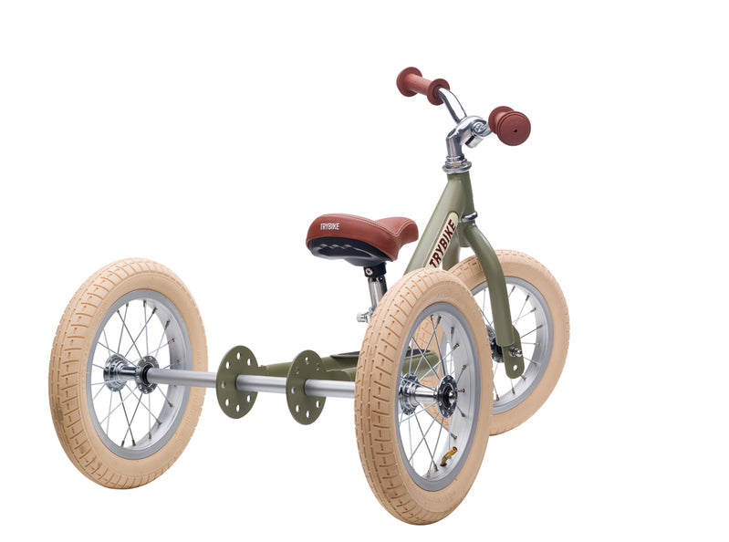 Children's balance bike with large wheels on a white background