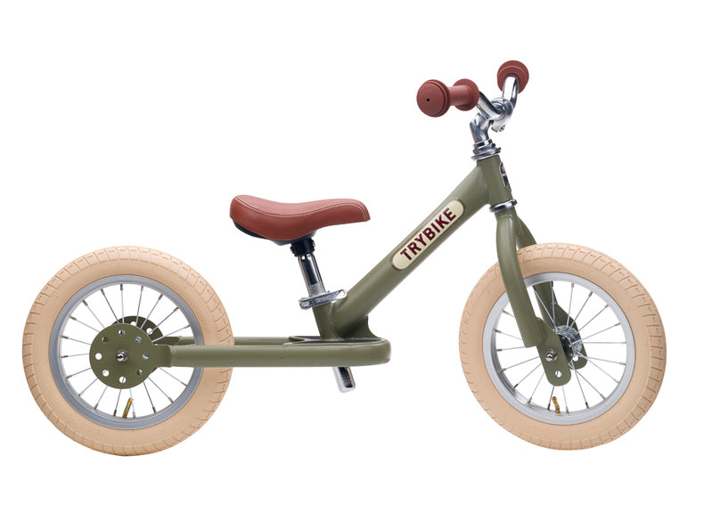 Children's balance bike with brown seat and wheels on a white background