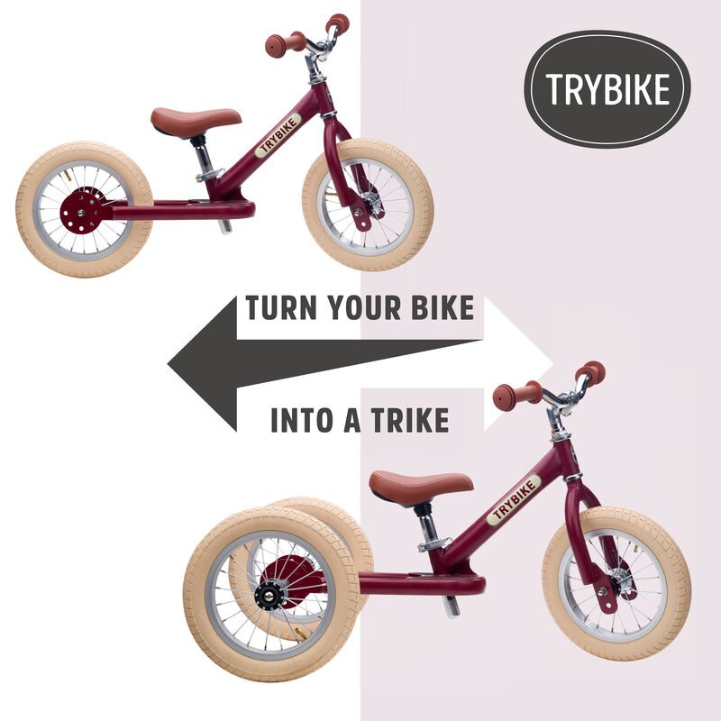 Red balance bike with a trike conversion kit on a light pink background, featuring the TRYBIKE brand.