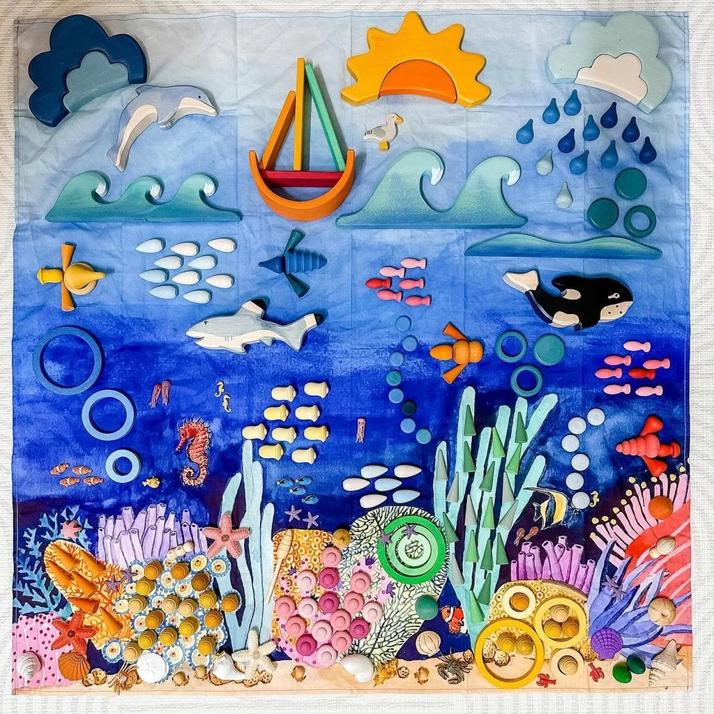 Colorful underwater scene with various sea creatures and objects on a blue background