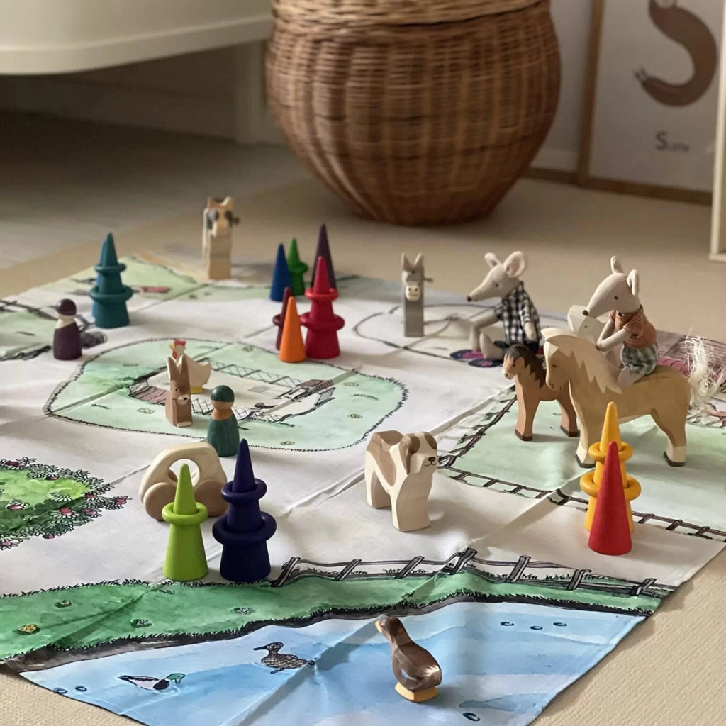 Wooden animal figurines on a game board with a woven basket in the background.