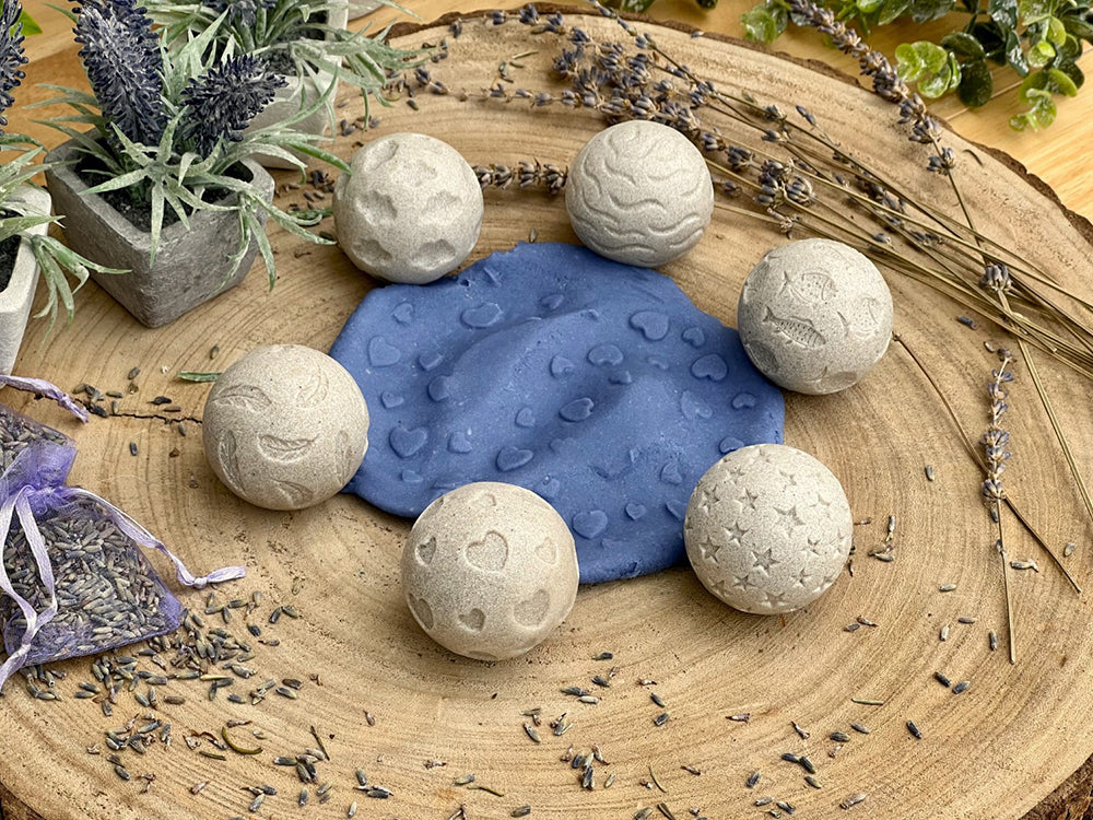 Bath bombs on a wooden surface with lavender and plants
