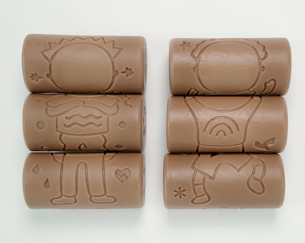 Set of six brown cylindrical toys with embossed designs on a white background