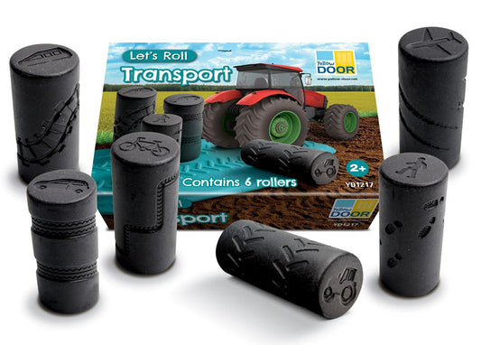 Black cylindrical rollers with a toy truck packaging in the background